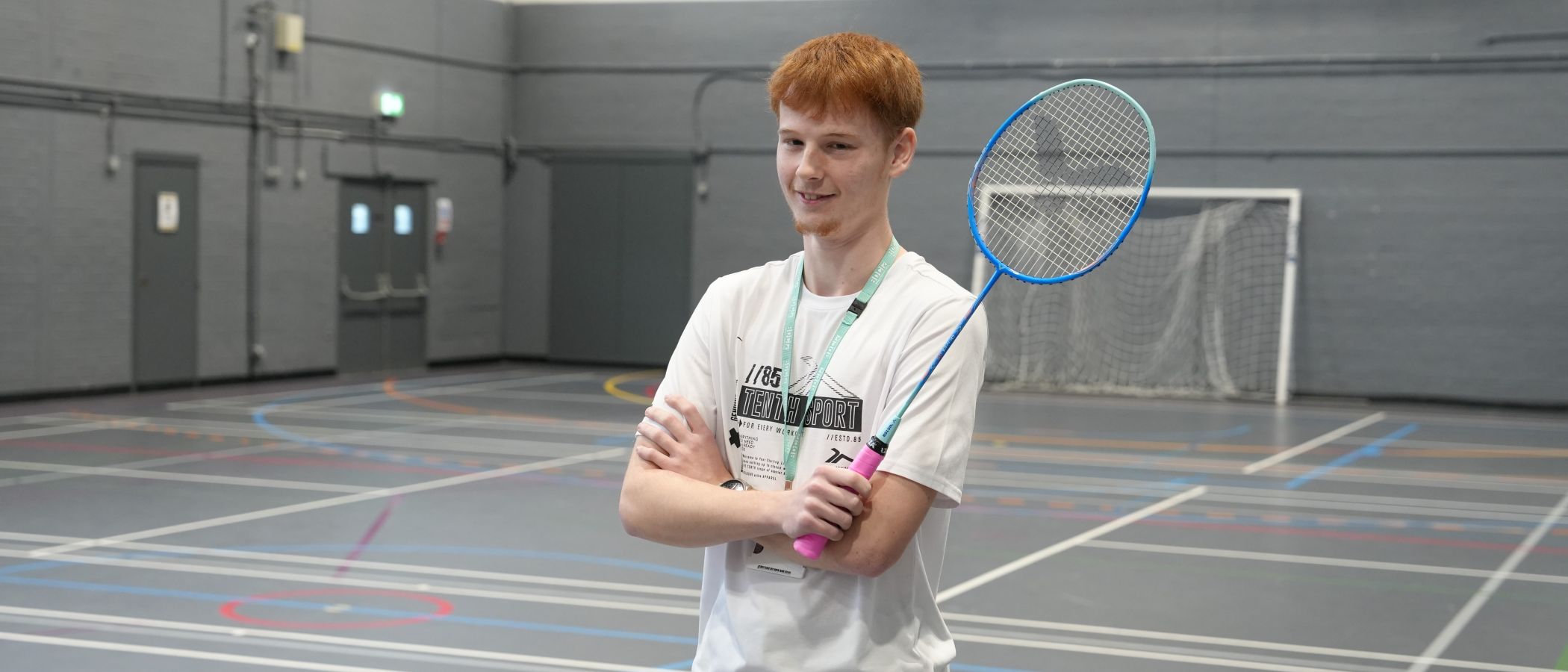 Sport student stood holding badminton racket