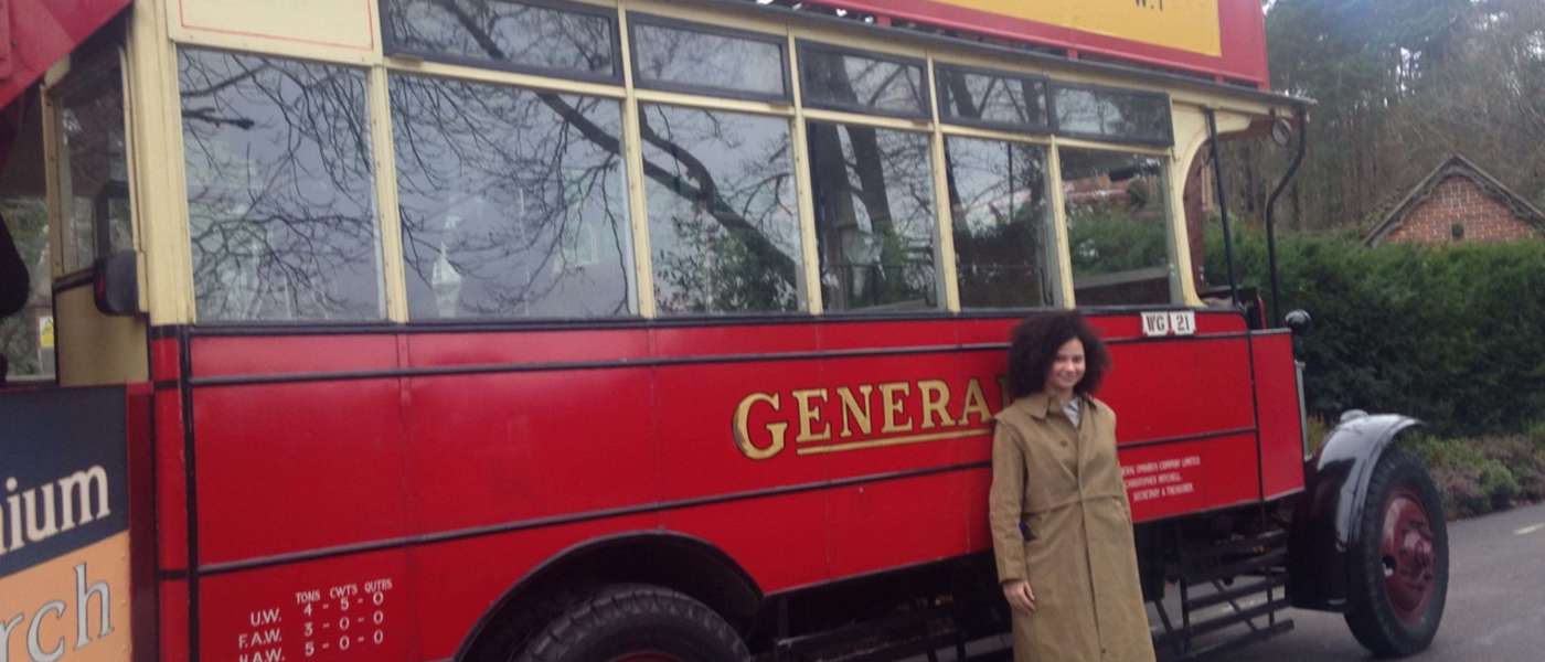Amaya standing next to the bus dressed as an extra