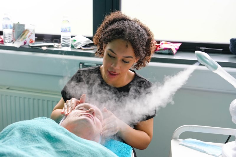 A student carrying out a facial whilst taking part in the beauty therapy competition