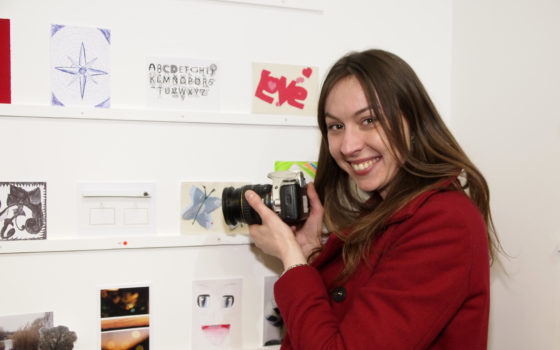Photography student indre neiberkaite posing with her artwork at last year s post picasso art benefit