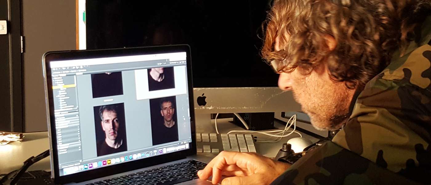 Jamie Morgan viewing live capture of portraits of photography lecturer David Bennett that he made