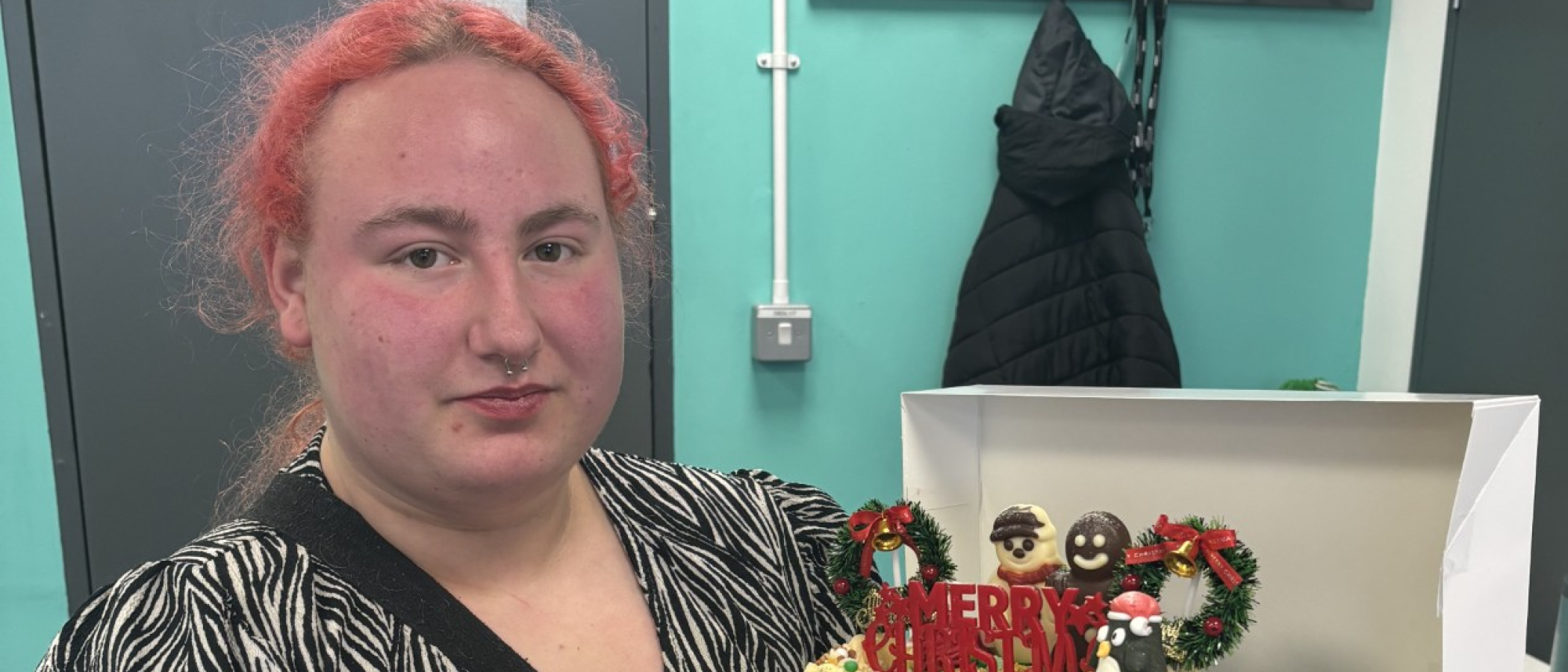 Kiera with the Christmas cake she baked for her classmates