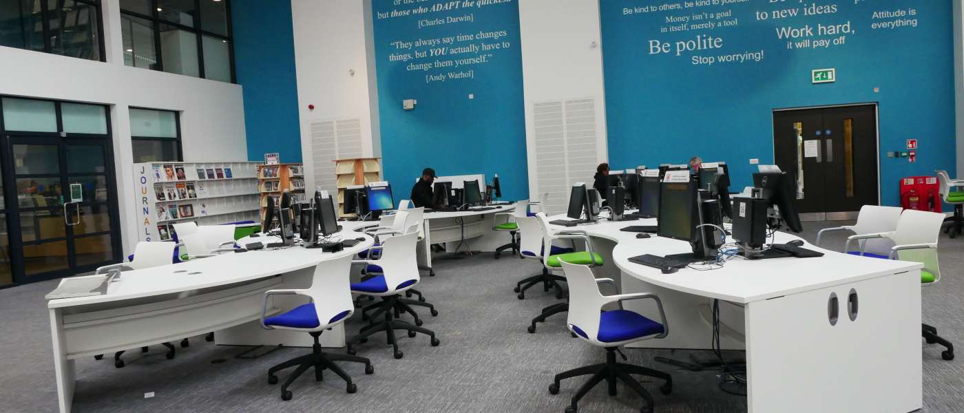 Desks, chairs and computers in the Learning Resource Centre (LRC) at the Rush Green Campus