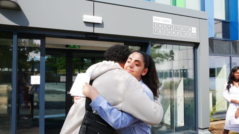 East London Institute of Technology BTEC student Jasmine Mustafa right hugs fellow BTEC student Demar Bellamy Foster after rece