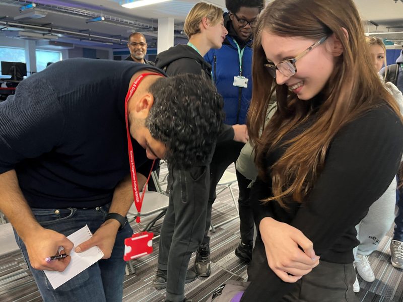 Olympic Sprinter Adam Gemili gives student Lacey Ann Fullerton his autograph