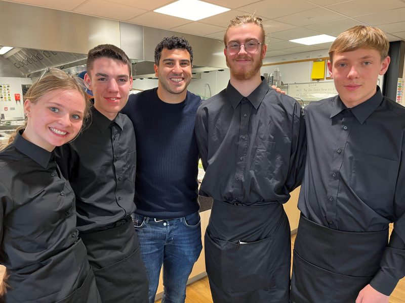 Olympic Sprinter Adam Gemili was cooked and served lunch by food studies students Riley Williams on the right