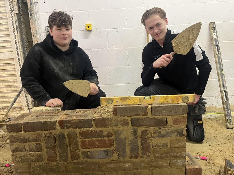 Brickwork level 1 students Alfie Hazel 16 and Bobby Soskin 16 both from Dagenham building a wall