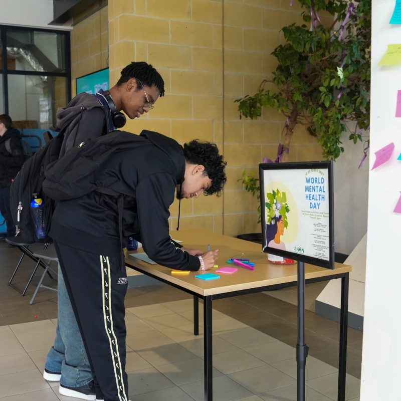 College breaks mental health stigma students fill post it notes with positive messages