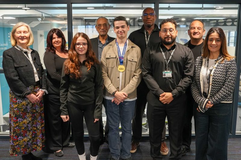 Gold for young engineer Harvey with his family and college staff