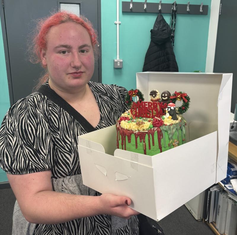 Kiera with the Christmas cake she baked for her classmates