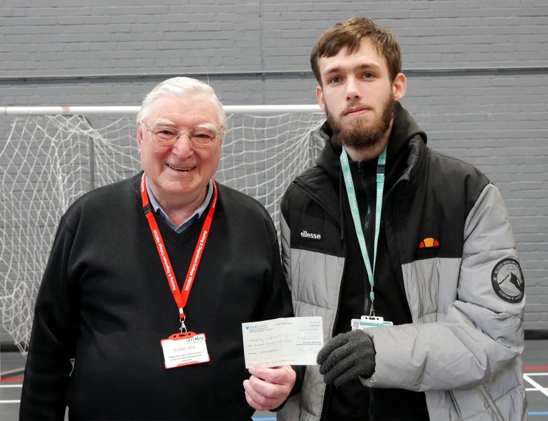 Sports student David Edgeler from Dagenham presenting a cheque to Havering Mind Events and Partnership Manager Ciaran White