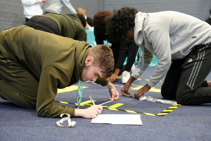 Students learn about cyber careers programming a robot called Edison around an obstacle course 1