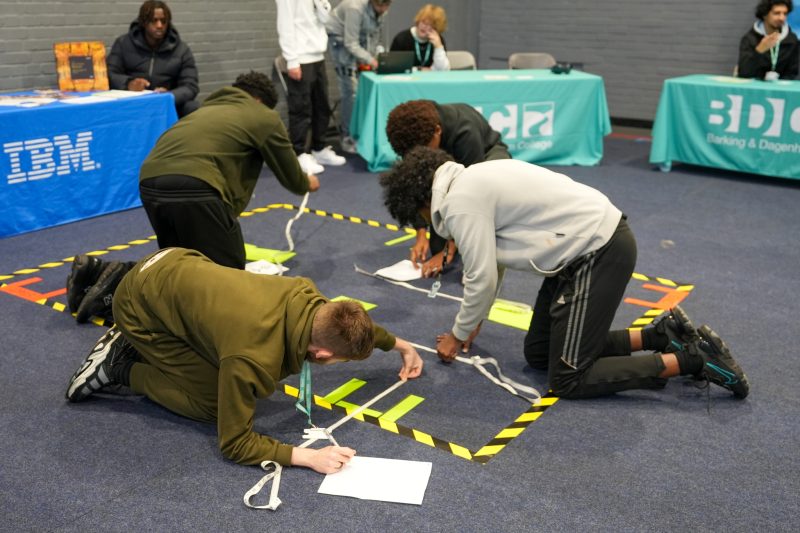 Students learn about cyber careers programming a robot called Edison around an obstacle course 2