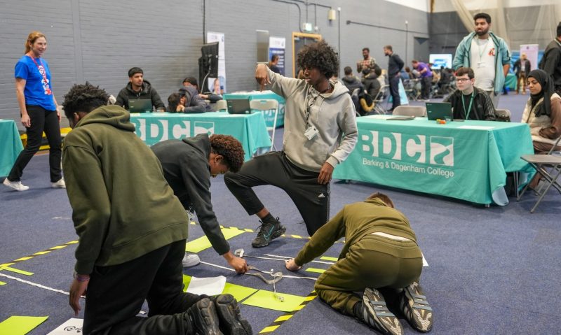 Students learn about cyber careers programming a robot called Edison around an obstacle course 3