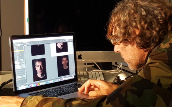 Jamie Morgan viewing live capture of portraits of photography lecturer David Bennett that he made