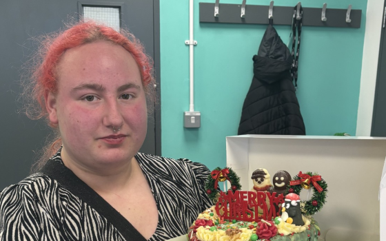 Kiera with the Christmas cake she baked for her classmates