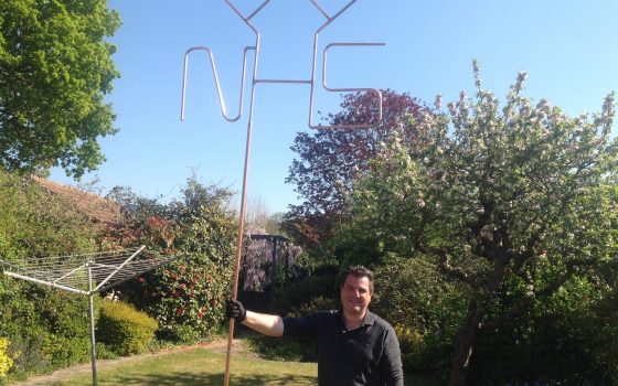 Plumbing lecturer Darren Myler from Barking Dagenham College has created a giant NHS sign from pipes which is on display outside his home