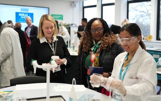 Science student Fiona Puro does a DNA experiment watched by Cllr Elizabeth Kangethe