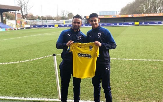 Zayn Bux with his new shirt Academy manager Marvin Hamilton of AFC Wimbledon