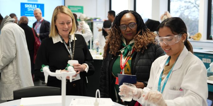 Science student Fiona Puro does a DNA experiment watched by Cllr Elizabeth Kangethe